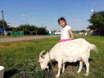 Full length portrait of smiling girl on a field