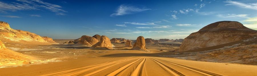 Panoramic view of road passing through desert