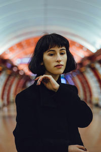 Portrait of young woman standing in tunnel