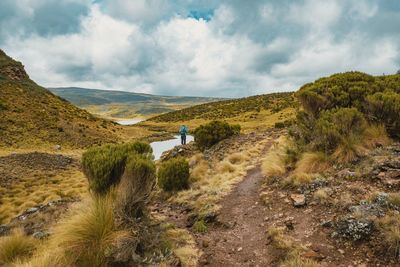 Rear view of hiker at a scenic view point at lake ellis, mount kenya national park, kenya