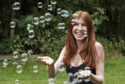 Smiling young woman with bubbles