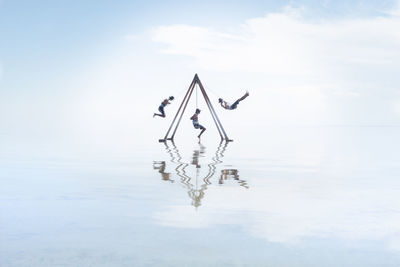 Self portrait on swing set in reflection on salton sea californi