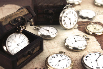 High angle view of pocket watches on table