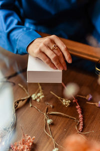 Woman's hand lies on the table