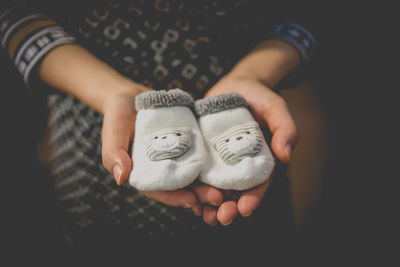 Close-up of hand holding baby socks