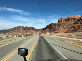 Cars on road against sky