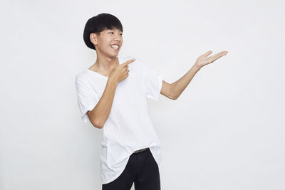 Portrait of a smiling young woman against white background