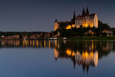 Reflection of buildings in city at waterfront