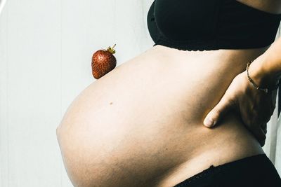 Midsection of woman with fruits