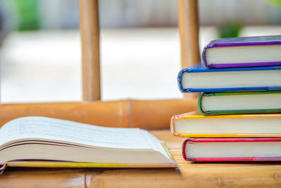 Stack of colorful books on wooden table