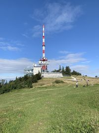 Tower on field against sky