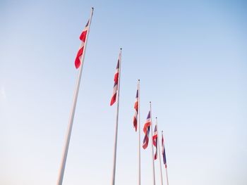 Low angle view of flags against sky