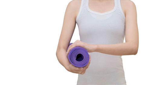 Midsection of woman holding umbrella against white background