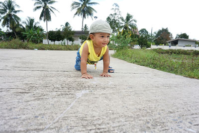 Full length of boy on palm tree