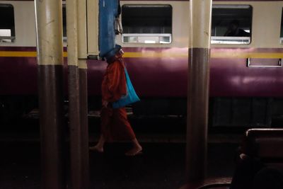 Rear view of man standing in bus