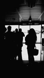 Silhouette people standing against white background