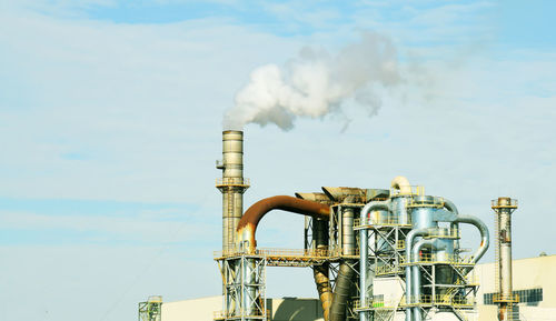 Low angle view of smoke stack against sky