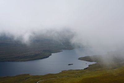Aerial view of landscape against sky during foggy weather
