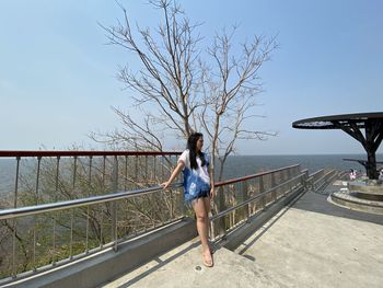 Full length of woman on bridge against sky