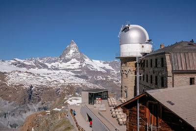 Snowcapped mountain against clear blue sky