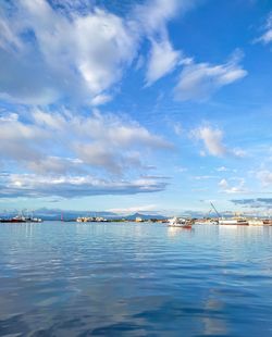 Sailboats in sea against sky