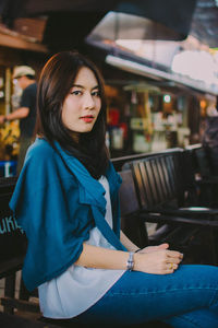 Portrait of woman sitting on bench