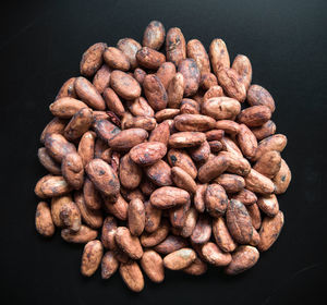 High angle view of coffee beans against black background