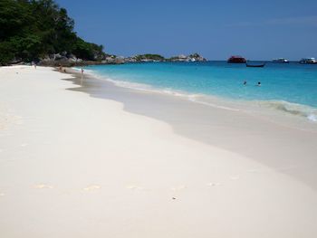 Scenic view of beach against clear blue sky