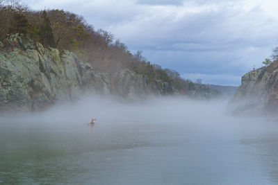 Scenic view of foggy river