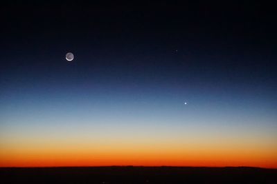 Scenic view of moon against clear sky at night