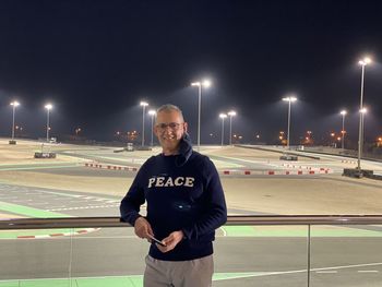 Portrait of smiling man about to go kart at the bahrain go karting track.