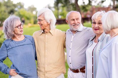 Portrait of female friends standing in park