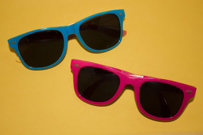 High angle view of sunglasses on yellow table