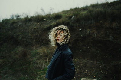 Side view of woman standing on field