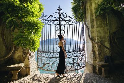 Rear view of woman standing against wall