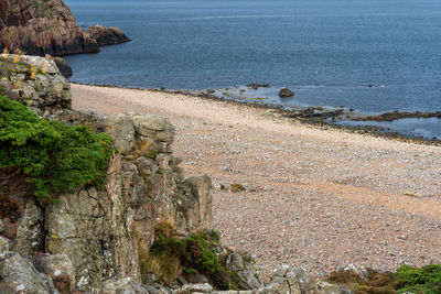 High angle view of rocks by sea