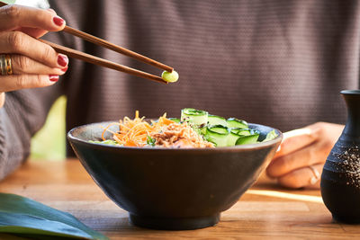 Close-up of person holding food on table