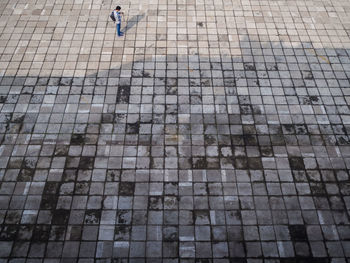 High angle view of people on cobblestone