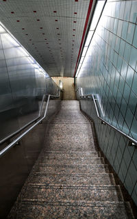 Rear view of man walking on footbridge