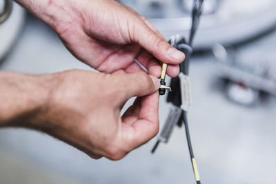 Close-up of man working at electronic component