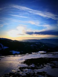 Scenic view of frozen lake against sky during sunset