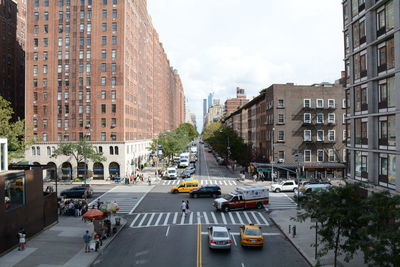 High angle view of vehicles on street amidst buildings in city