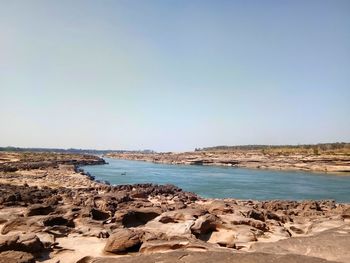 Scenic view of beach against clear sky