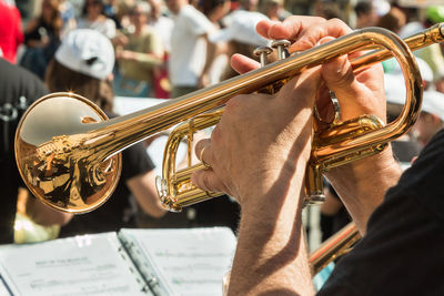 Midsection of man playing trumpet