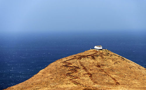 High angle view of house on cliff against sea