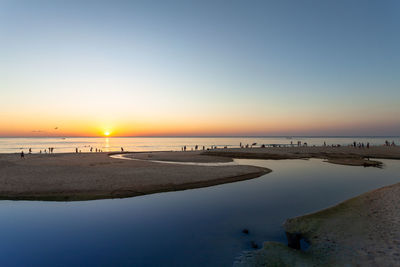 Scenic view of sea against clear sky during sunset