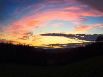 Silhouette of landscape against dramatic sky