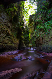 View of river flowing through cave