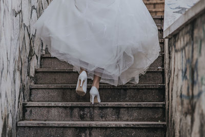 Low section of bride moving up on staircase