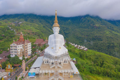 High angle view of statue amidst buildings against sky